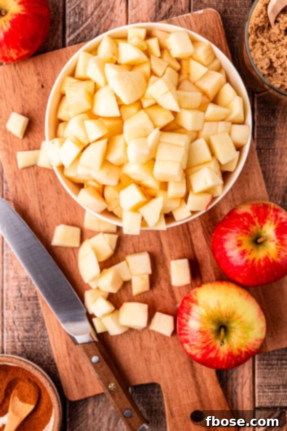 Warm Blueberry Apple Crisp 10 Overhead photo of apples being chopped on a cutting board.