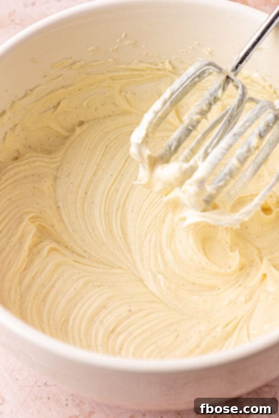 Cream cheese, powdered sugar, and vanilla beaten in a mixing bowl.