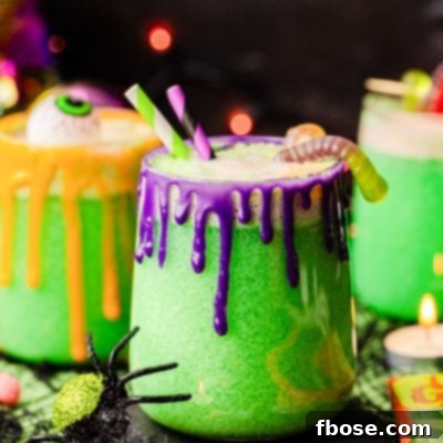Close up photo of glasses of Halloween punch on a table with decorations scattered around.
