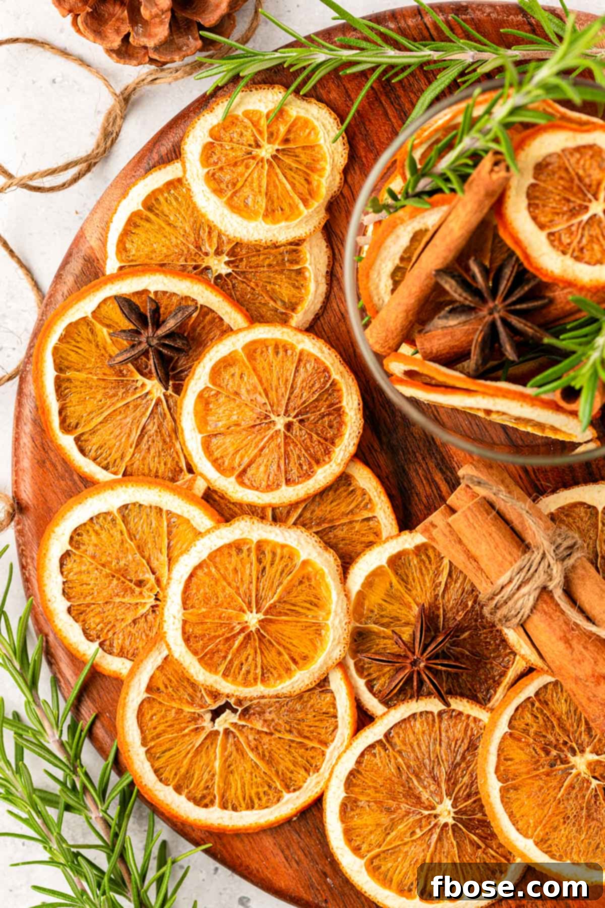 Oven-Dried Orange Slices 13 An overhead shot of perfectly sliced and dried oranges arranged neatly on a rustic wooden board, ready for storage or use.
