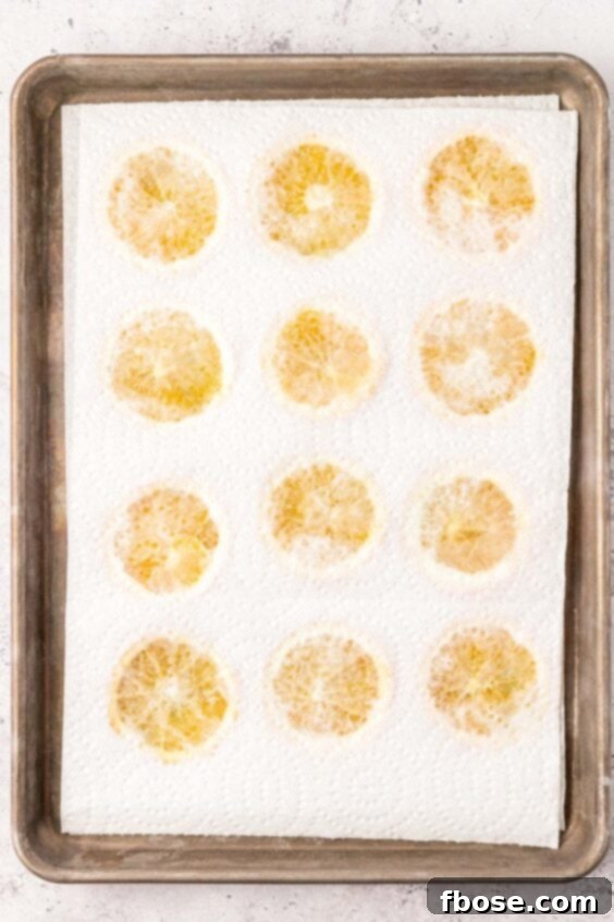 Paper towels lining orange slices to pull out moisture.