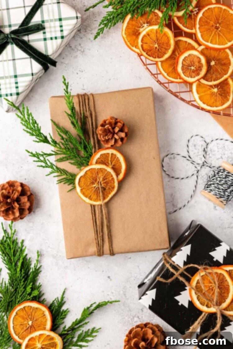 Oven-Dried Orange Slices 10 A beautifully wrapped book in brown paper, tied with twine and garnished with a dried orange slice and pinecones.