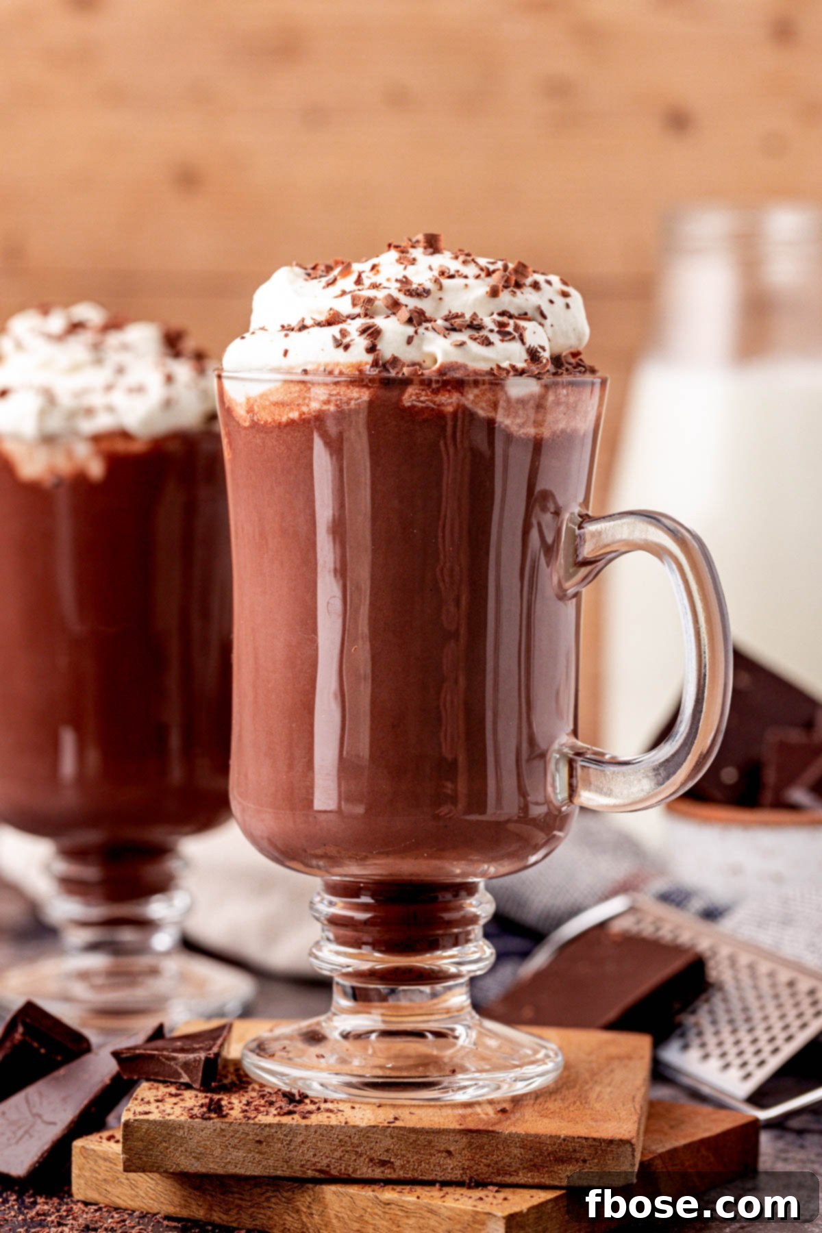 A close-up of a mug of hot chocolate, with the focus on the rich, dark liquid, steam rising invitingly.