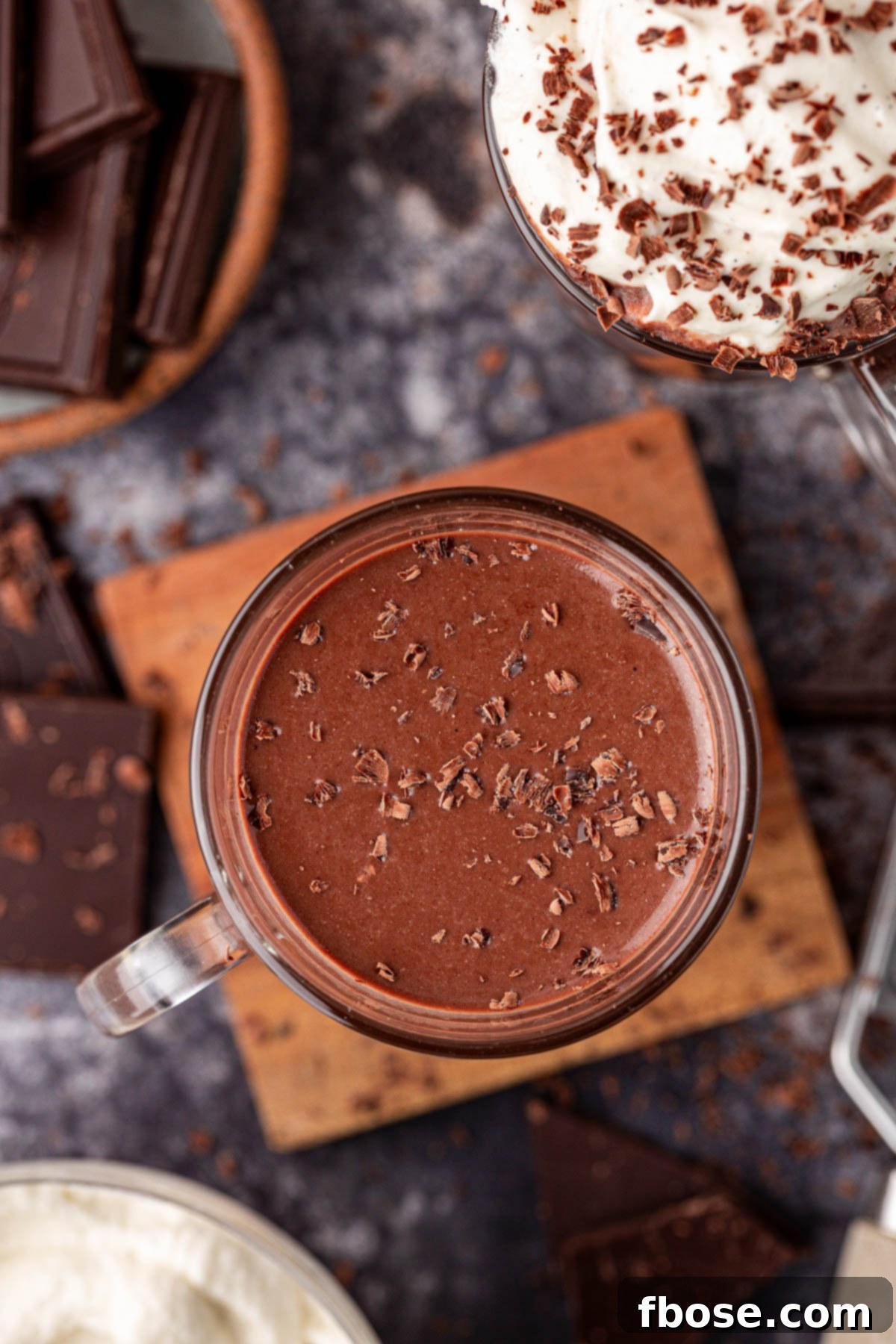 Overhead shot of a mug brimming with thick, dark hot chocolate, ready to be enjoyed on a cold day.