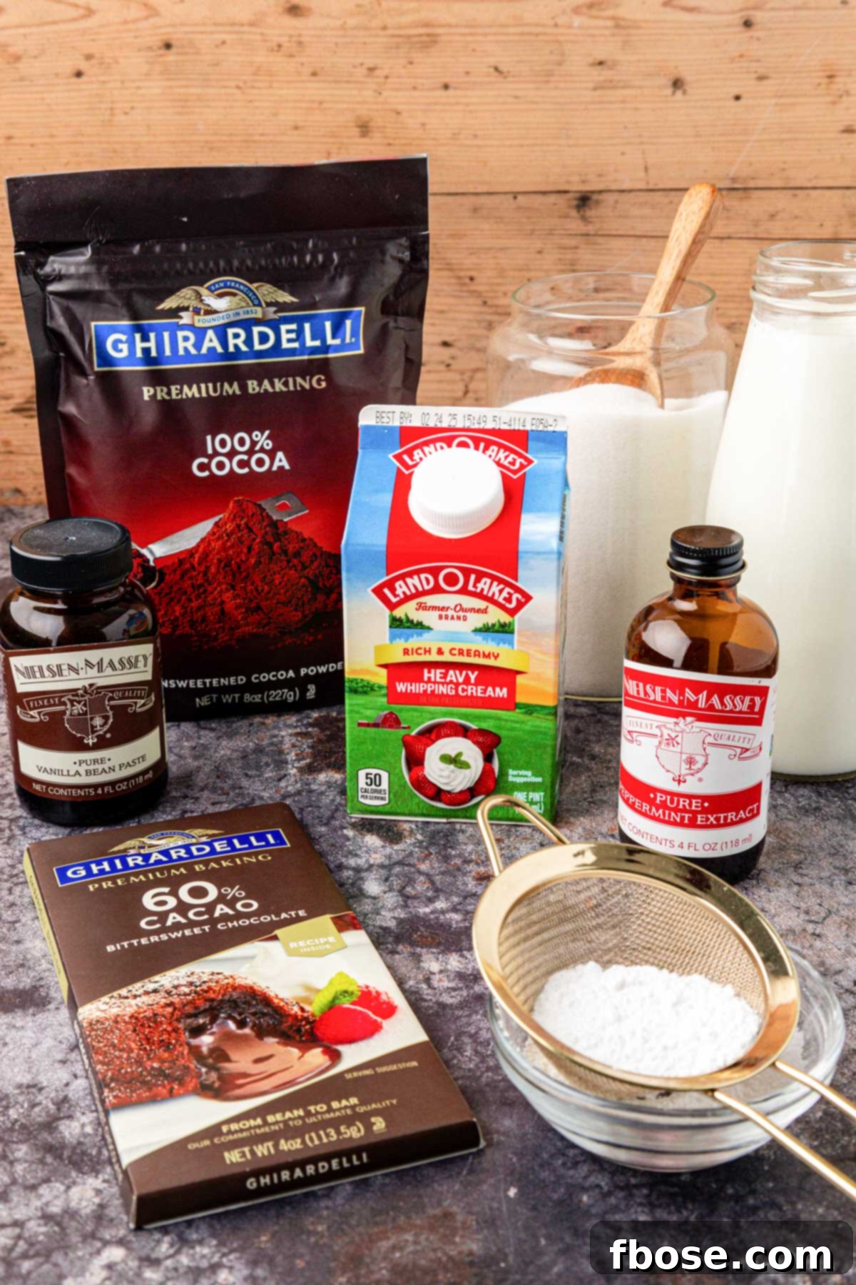Assortment of fresh ingredients laid out on a table to make Tini's hot chocolate, including milk, cream, chocolate, and cocoa powder.