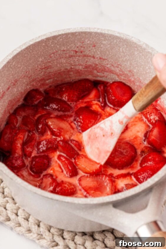 Strawberry filling being made in a pot.
