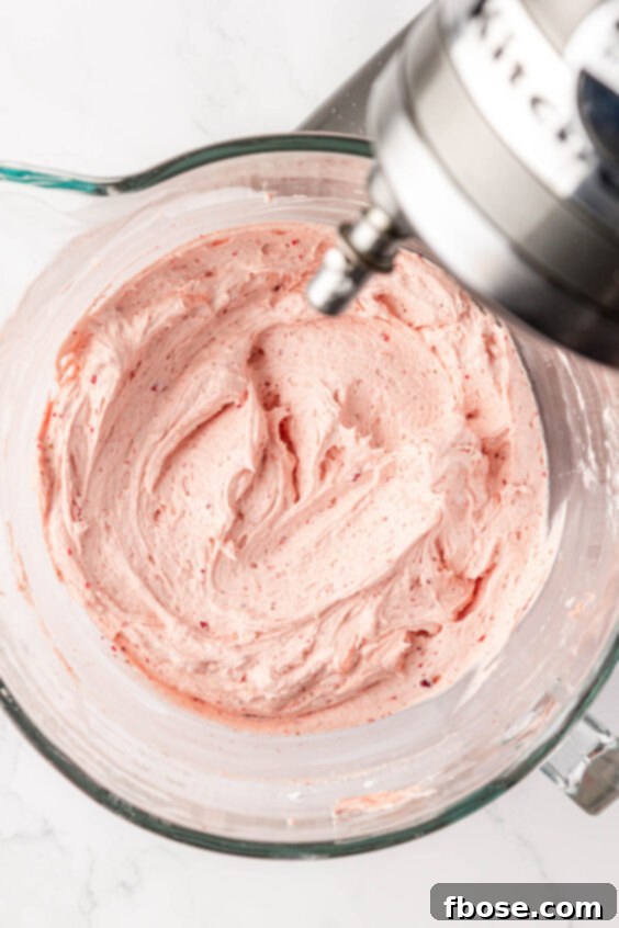 Strawberry frosting in a mixing bowl.