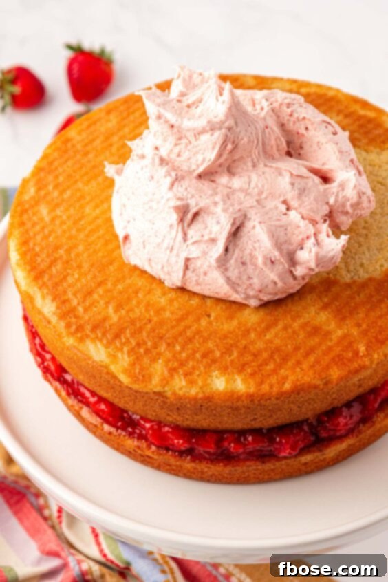 Frosting being added to cake.