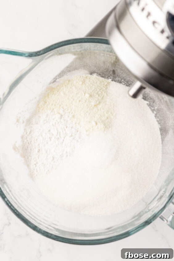 Sugar and flour in a glass mixing bowl.
