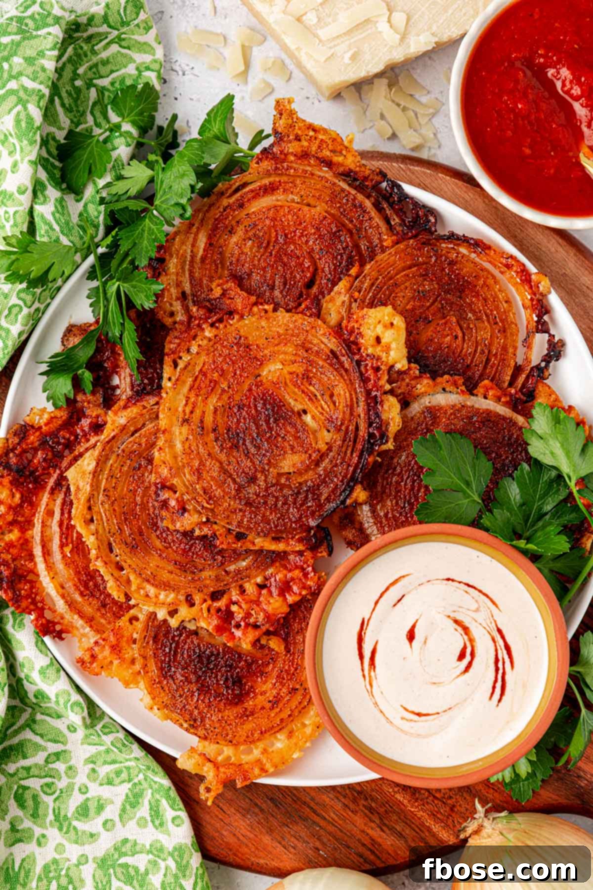 Overhead photo of a plate or viral onion ring chips, golden and crispy.
