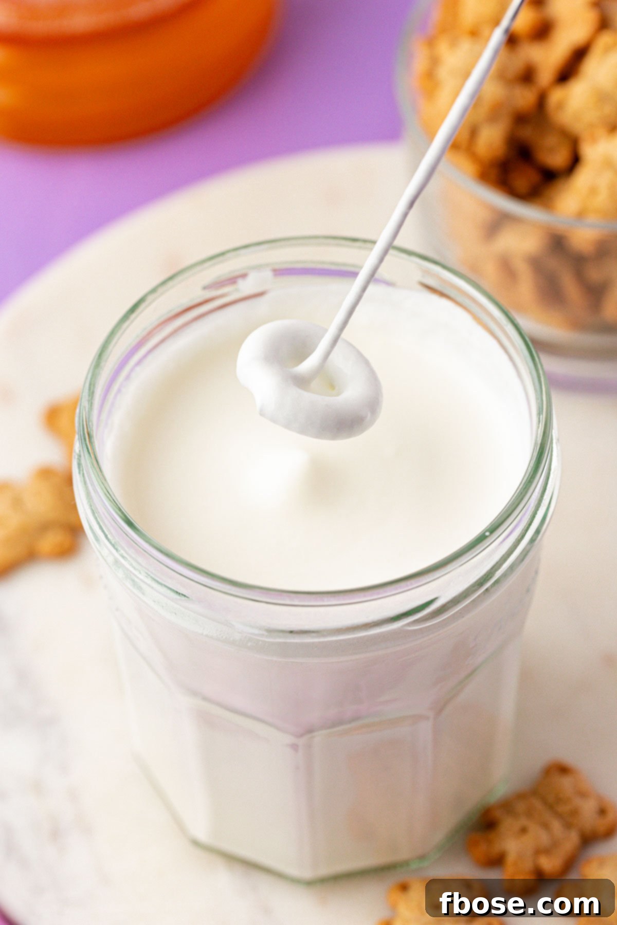 Graham Bear Bliss Latte 5 Homemade cold foam being vigorously shaken in a glass jar until thick and creamy.