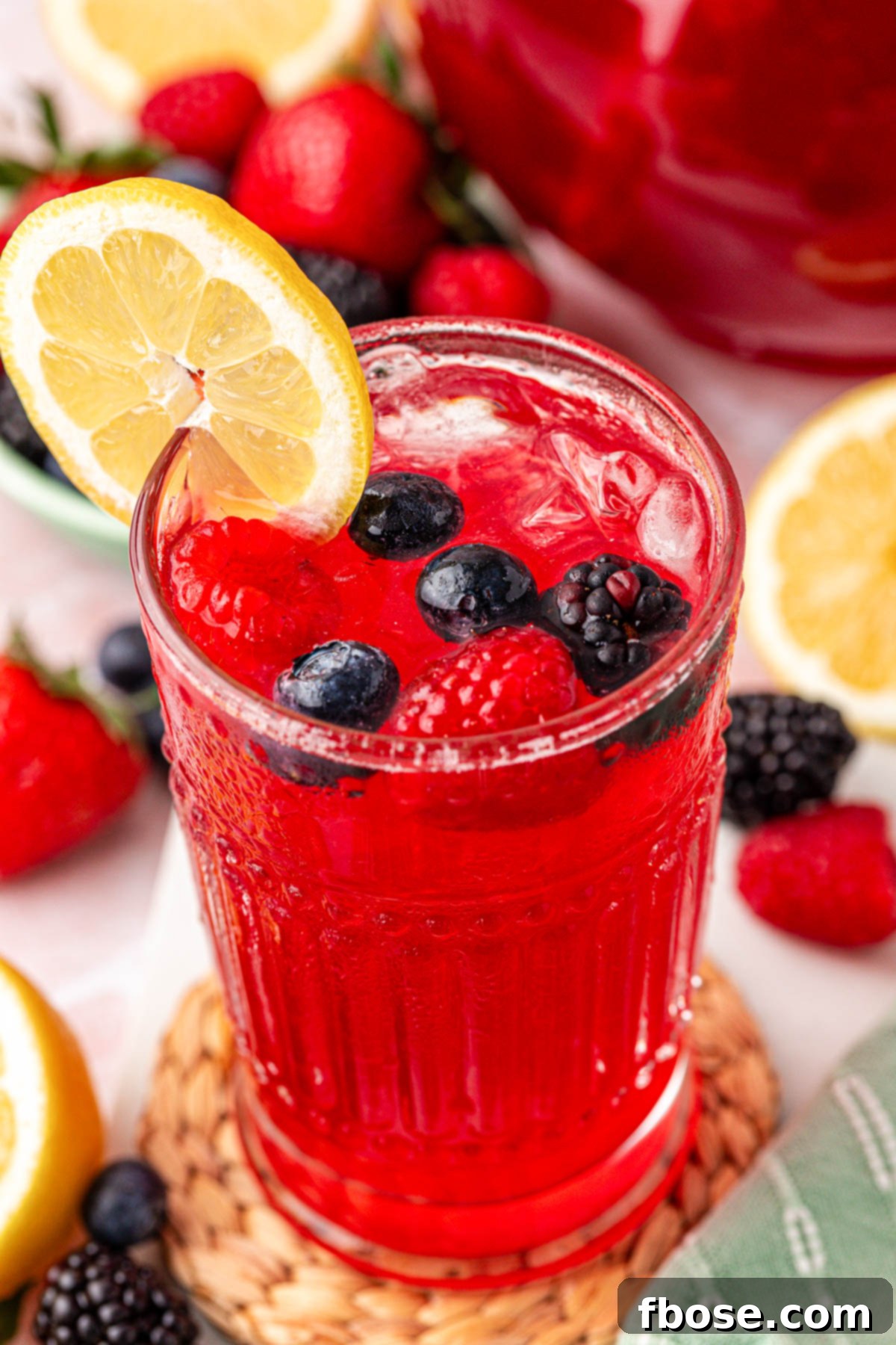 Close up photo of a glass of berry lemonade.