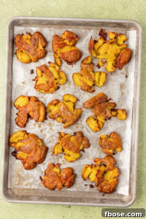 Crispy smashed potatoes on a sheet pan.