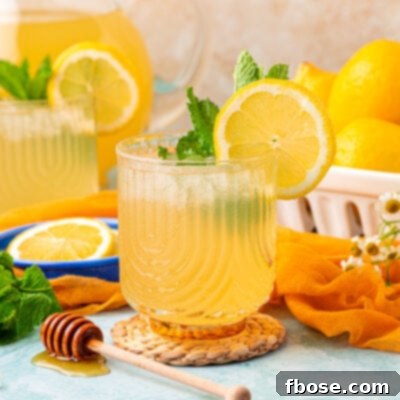 Zesty Honey Delight 8 Two glasses of honey lemonade on a blue table.