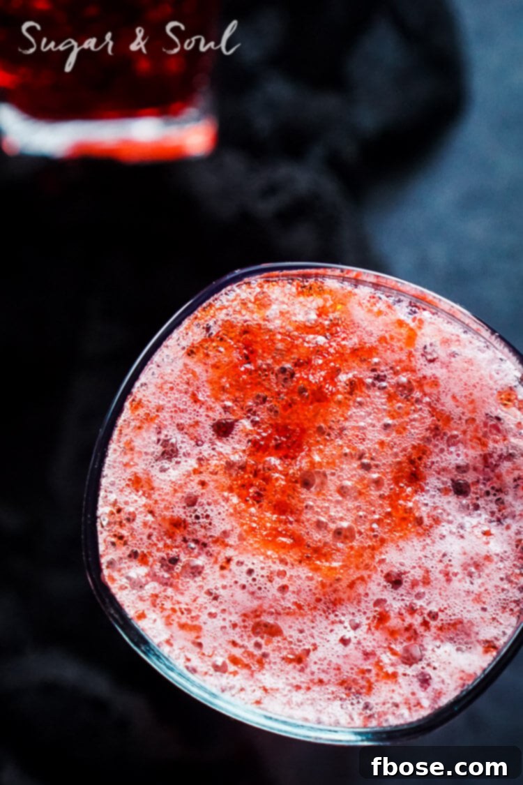 The Blood and Guts Cocktail standing tall in a dimly lit setting, evoking a Halloween or zombie apocalypse atmosphere.