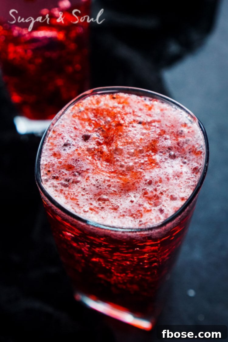 The Blood and Guts Cocktail served in a tall glass, highlighted with dramatic lighting for a sinister effect.