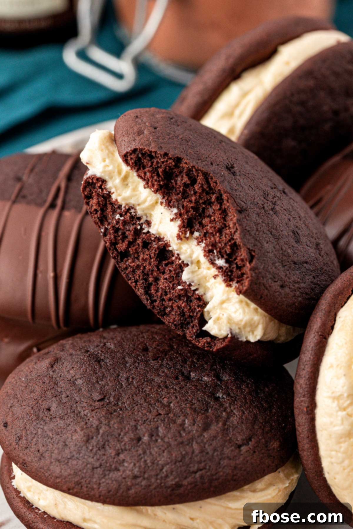 Whoopie pies on a a plate, one is missing a bite.