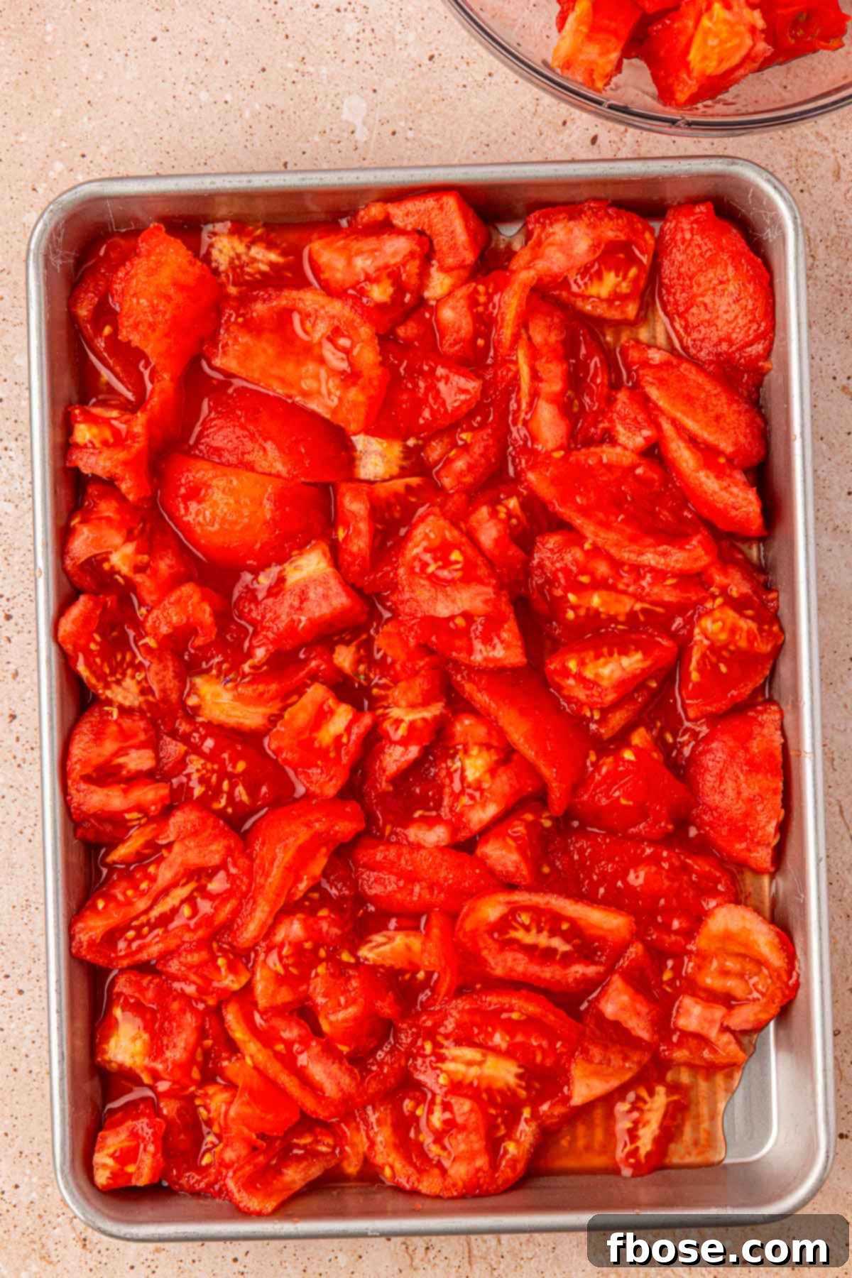 Sun-Kissed Tomato Simplicity 5 Chopped peeled tomatoes on a baking pan.