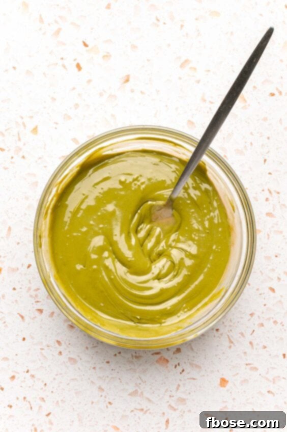 Pistachio cream and tahini mixed together in a bowl, creating a smooth filling base.