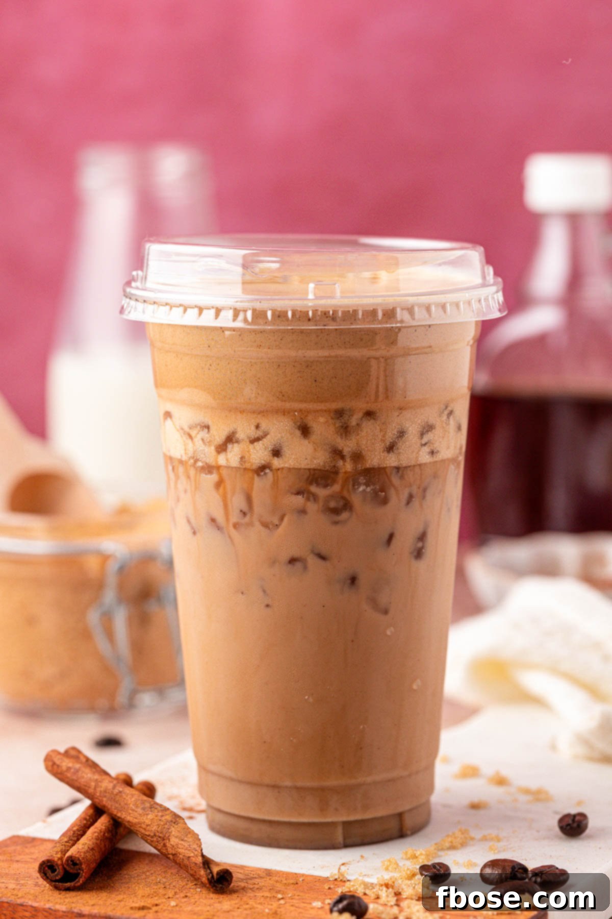 A plastic cup filled with an iced French toast latte.