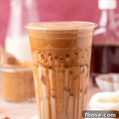Close up of a large cup filled with an iced latte.
