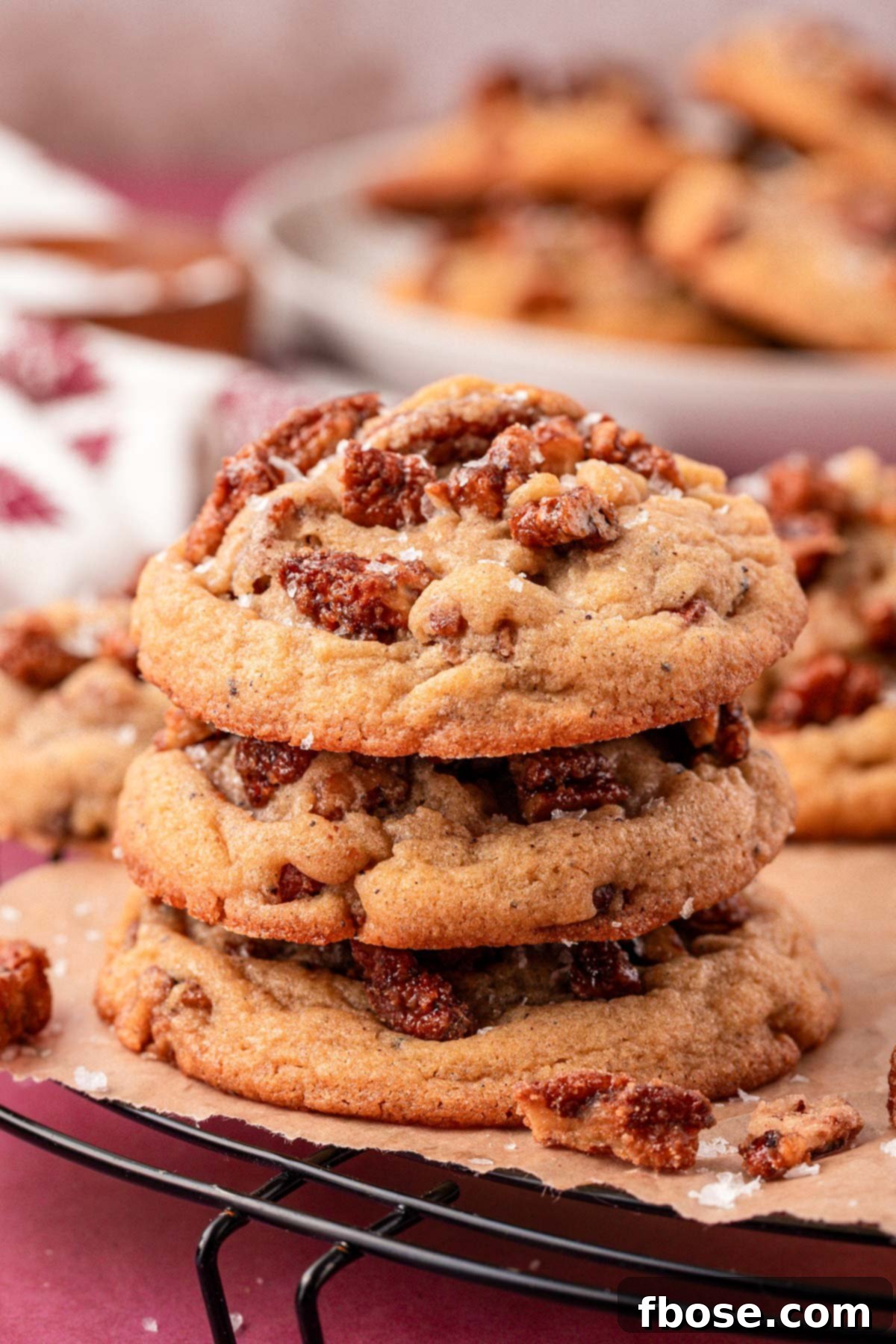 A perfectly stacked trio of Brown Butter Maple Pecan Cookies, showcasing their golden-brown edges and inviting texture.