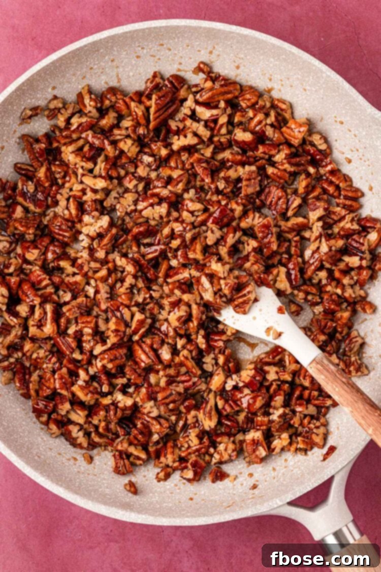 Close-up of a maple pecan cookie, showing its chewy interior and visible pecan pieces.
