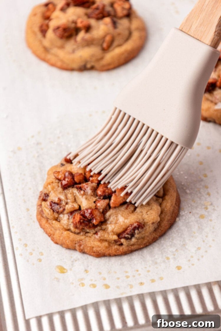 Pecan pieces being gently folded into the brown butter cookie dough.