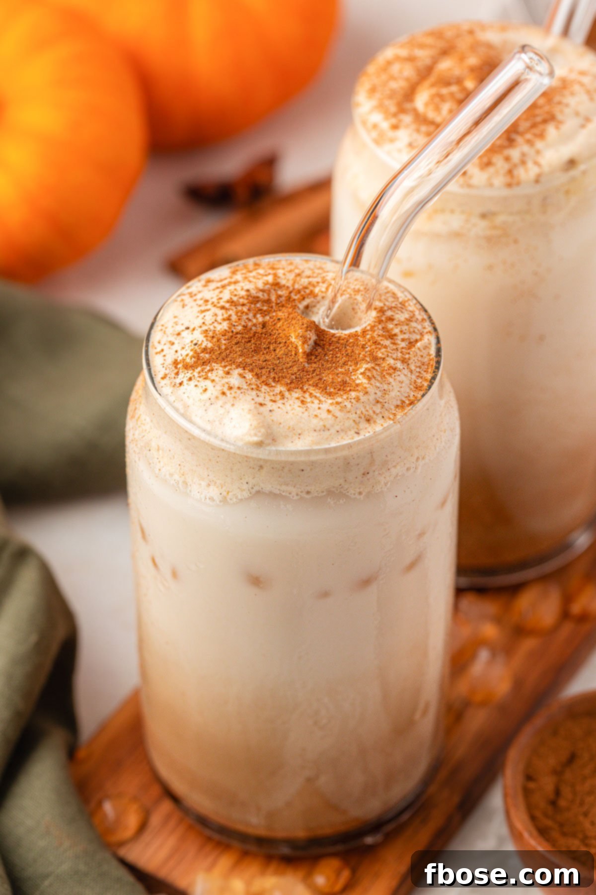 Close up of two glasses filled with pumpkin chai lattes.