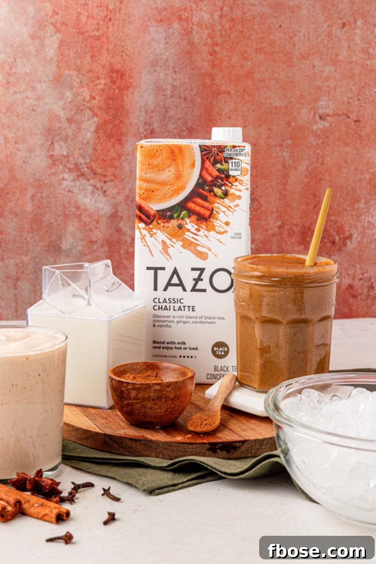 Ingredients to make a pumpkin chai latte on a table.