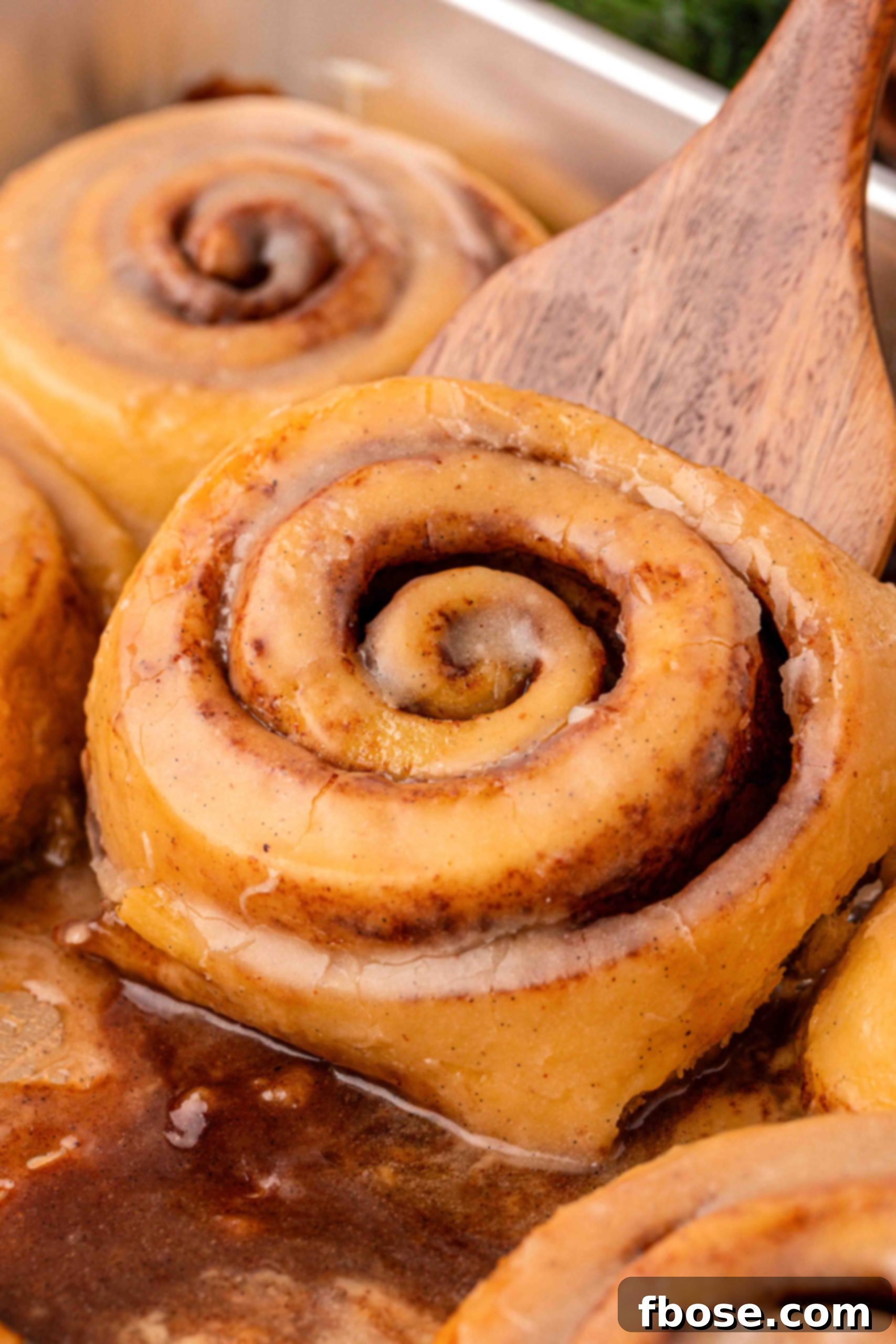 Eggnog Delight Swirls 3 Eggnog cinnamon rolls in a pan, ready to be served.