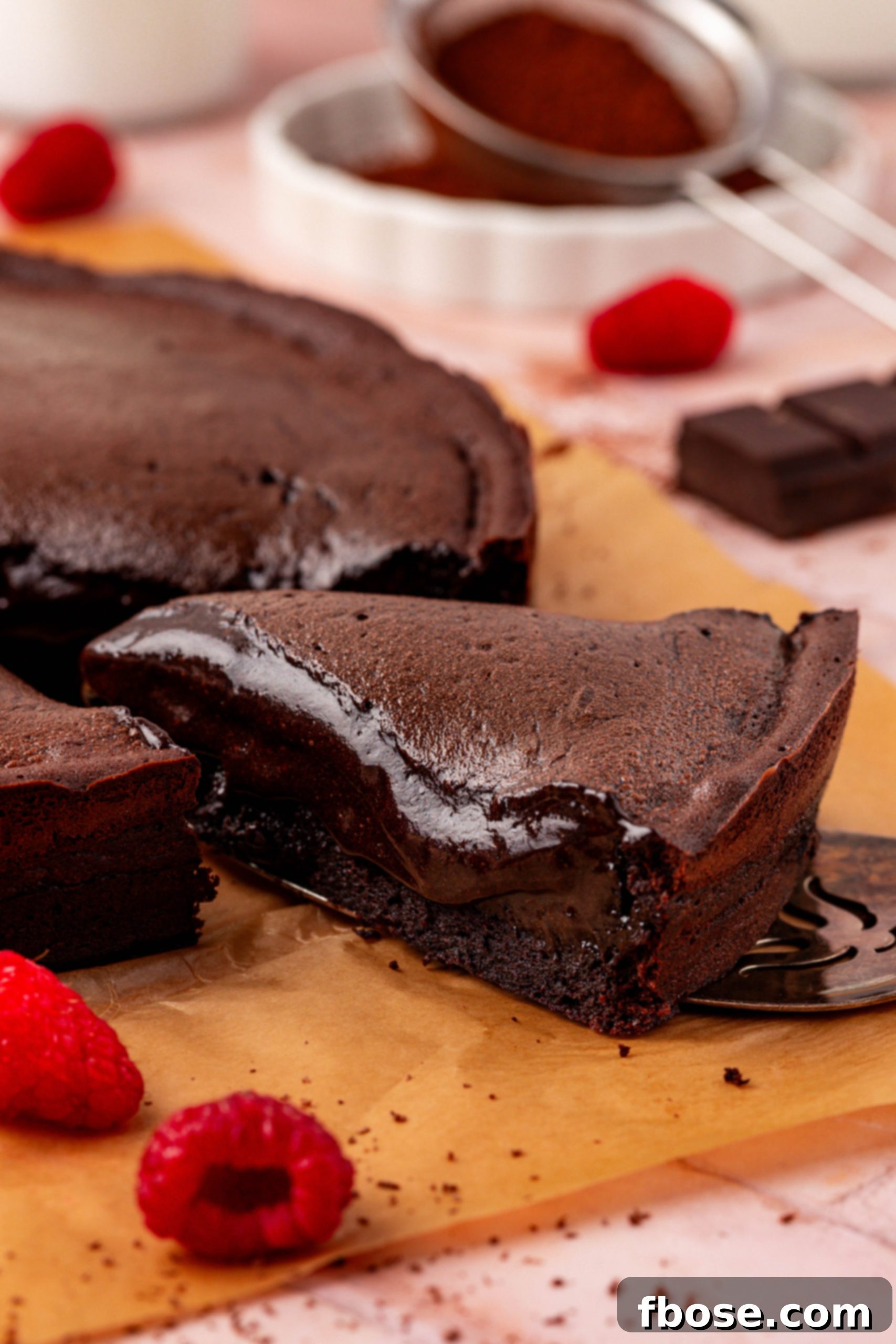 Close-up of a slice of Moelleux au chocolat cake on a table, showcasing its rich, molten center.