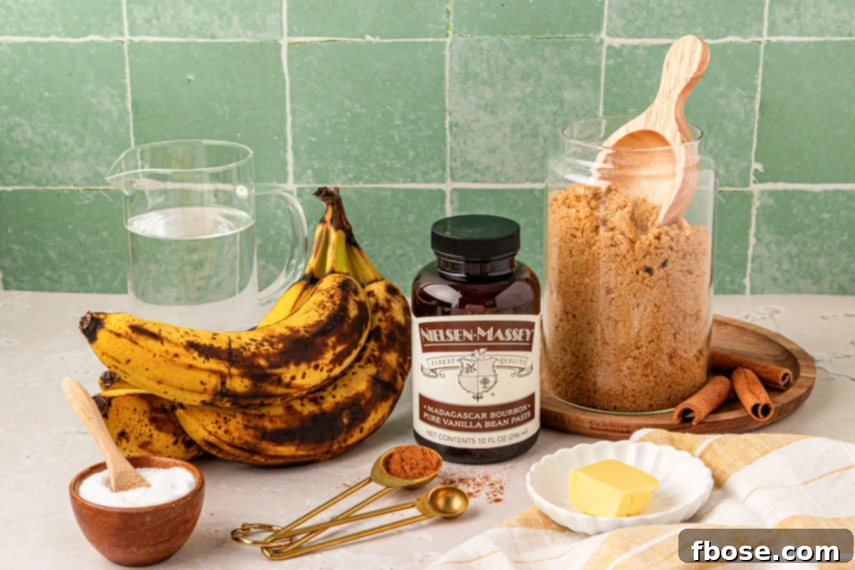 The seven simple ingredients for banana syrup arranged on a countertop, including bananas, brown sugar, and cinnamon.
