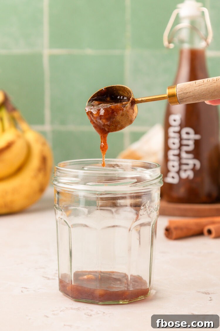 Add banana syrup to a glass.