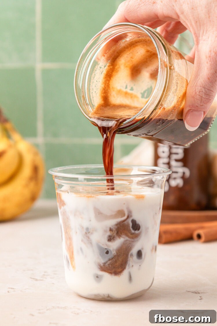 Pour the espresso into a cup with ice and milk.