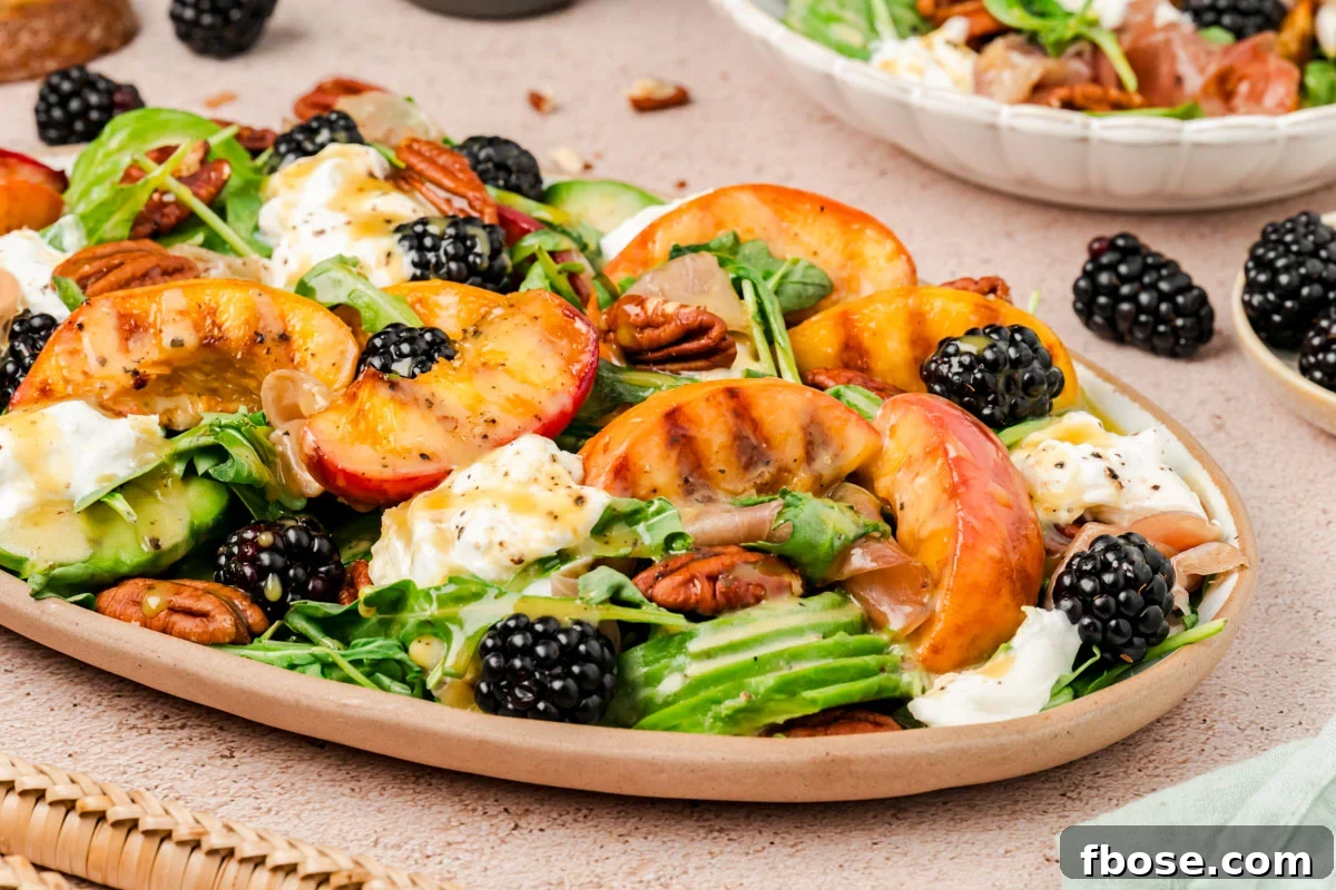 A plate filled with burrata peach salad.
