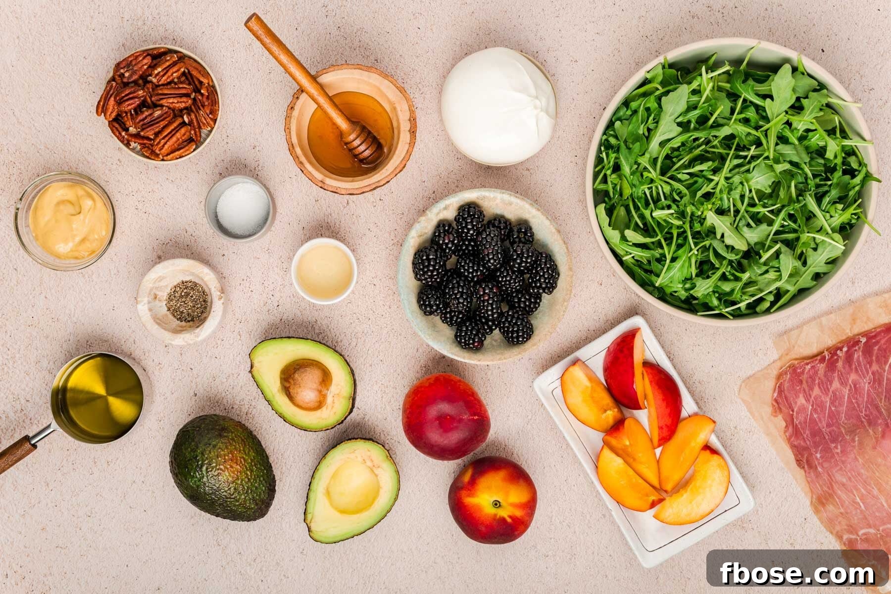 Ingredients to make peach burrata salad on a counter.