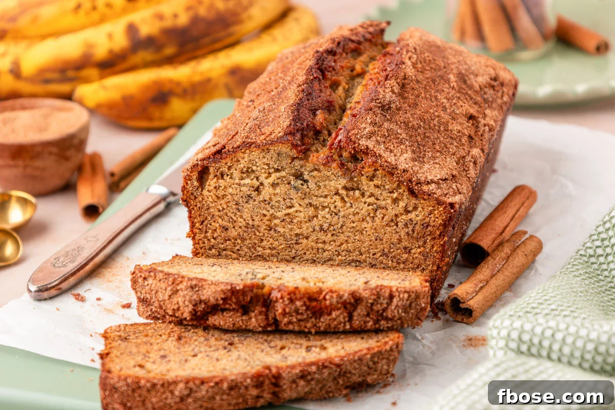Brown Butter Banana Bread Recipe 14 Slices of brown butter banana bread cut off a loaf on a cutting board.