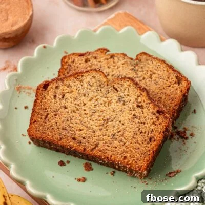 Brown Butter Banana Bread Recipe 15 Two slices of banana bread on a scalloped green plate on a table.