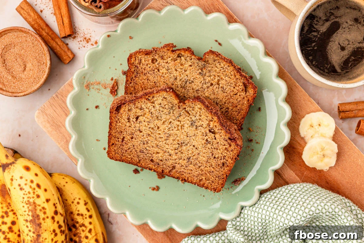 Brown Butter Banana Bread Recipe 3 Two slices of banana bread on a scalloped green plate on a table.