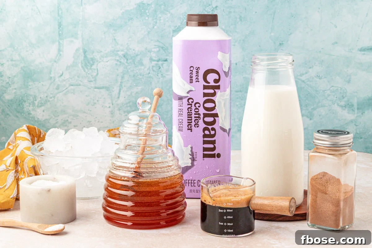 Ingredients to make a salted honey iced latte on a table.