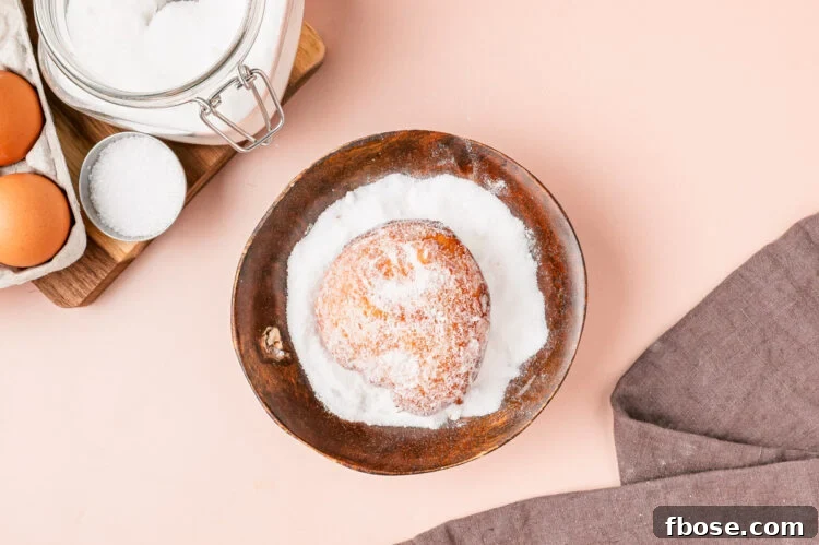 Coat malasadas in sugar.