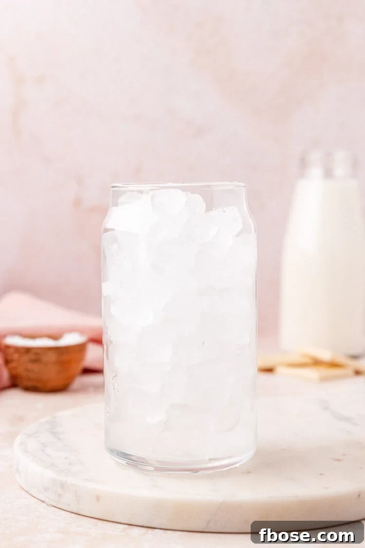 Fill a glass with ice.