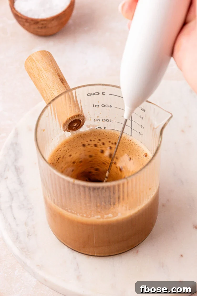 Brew espresso over powder and froth.